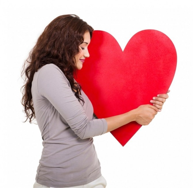 happy woman with hugging a heart shape isolated on white background